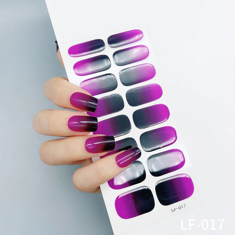 Full coverage nail art stickers sheet with 16 designs including cross, rose, tulip, and cartoon patterns.