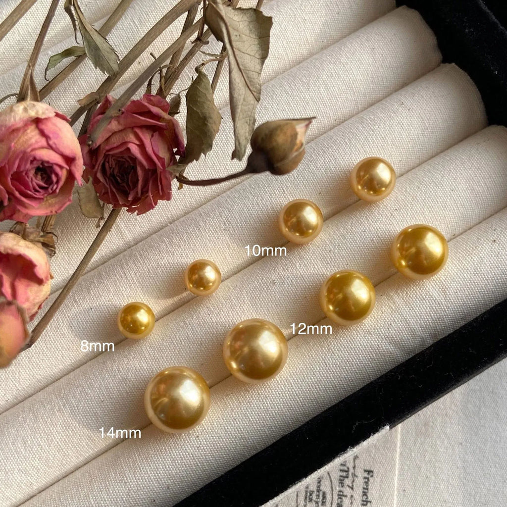 Large retro-style pearl stud earrings for women with a geometric eight-pointed star setting.