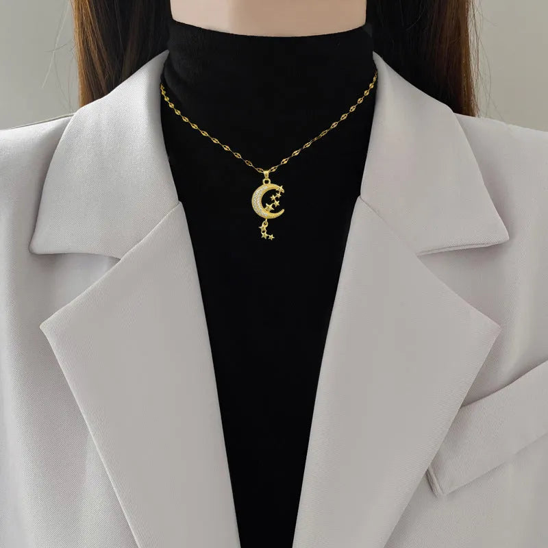 Geometric moon necklace with tassel detail in stainless steel and copper materials