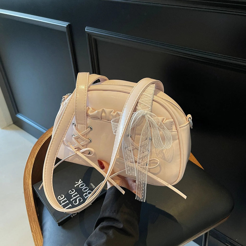 Women's white PU leather shoulder bag with a large bandage bow detail on the front.