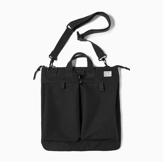 Canvas crossbody messenger bag in military green with shoulder strap and hard handle showing laptop compartment