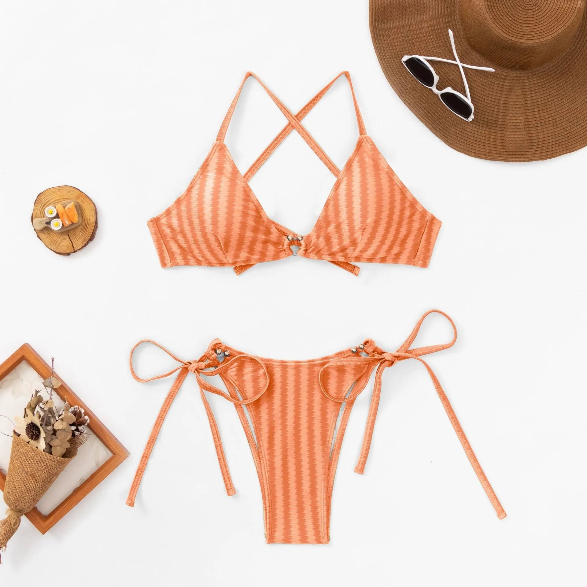 Women's orange bikini set with jacquard lace-up front detailing and split-bottom briefs on a mannequin.