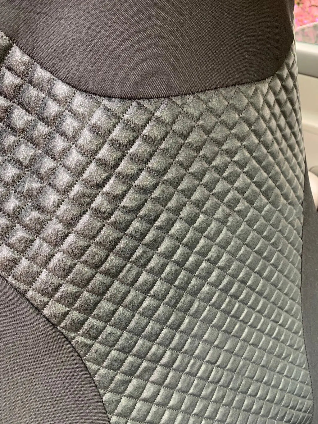 Black quilted automotive seat covers showing PU and polyester fabric construction with plastic hook fasteners