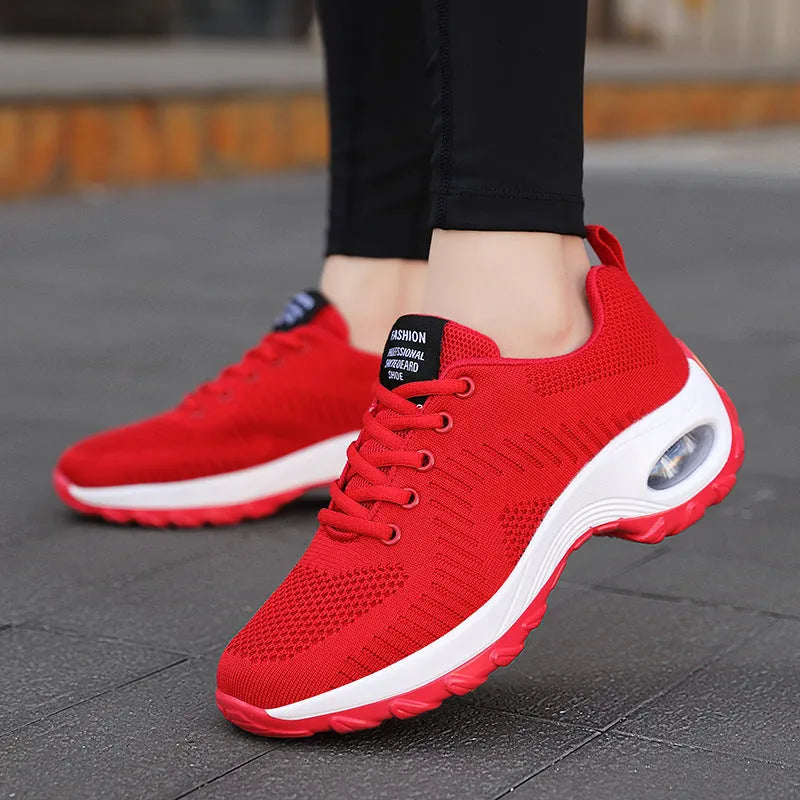Red and black women's low-top mesh sneakers with round toe and front lace-up.