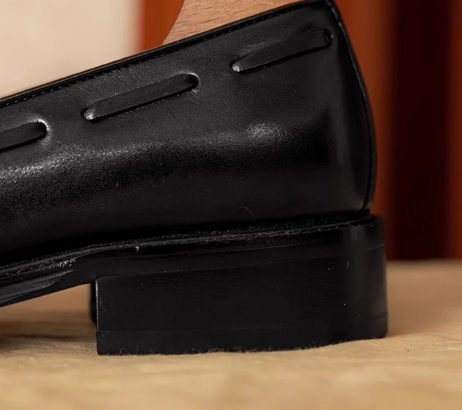 Men's black genuine leather loafers with fringed detail, rubber sole, and slip-on design