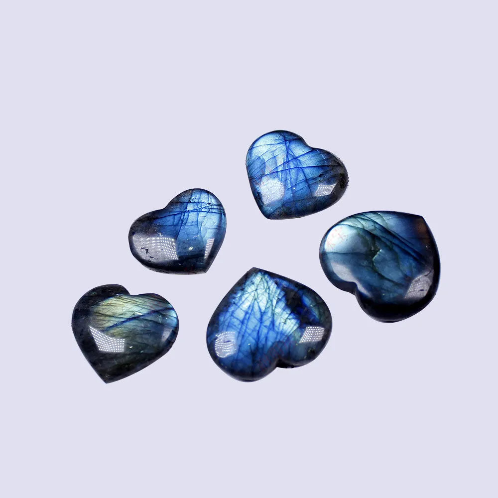 Natural blue feldspar heart-shaped handle play piece pendant on a white background.