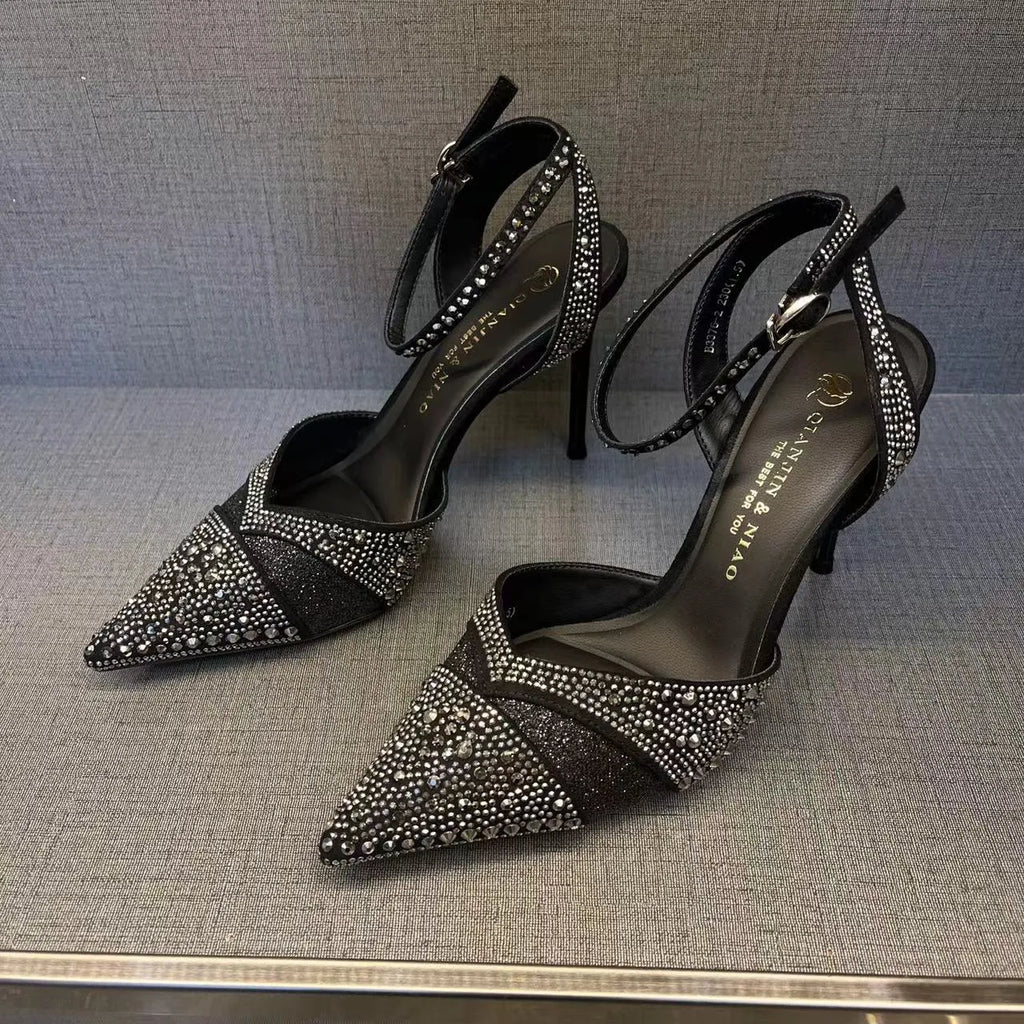 Women's black high heel shoe with stiletto heel, pointed toe, shallow cut, and red sole.