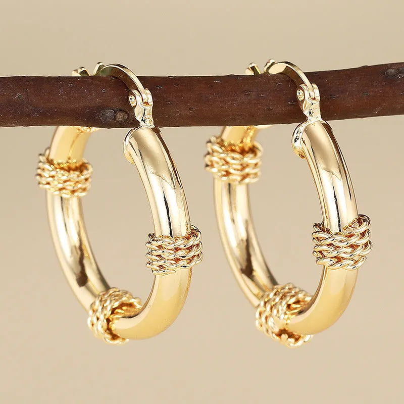 Geometric women's earrings with ring ear clip design in golden copper material