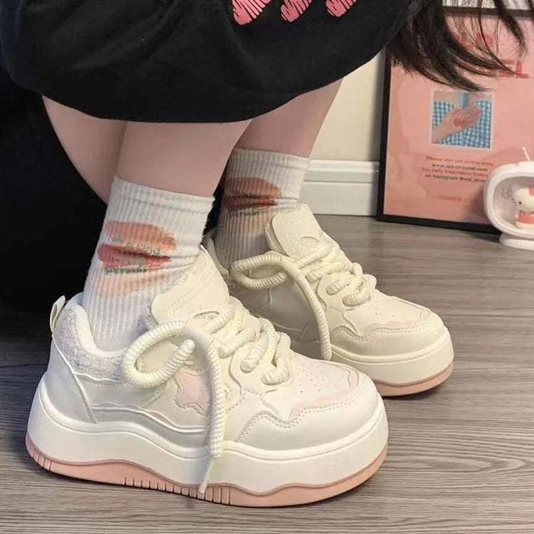 Women's green platform sneakers with round toe and lace-up design on a white background.