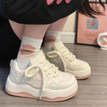 Women's green platform sneakers with round toe and lace-up design on a white background.