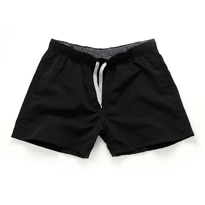 Men's polyester beach shorts for surfing in multiple colours including black white red and fluorescent options