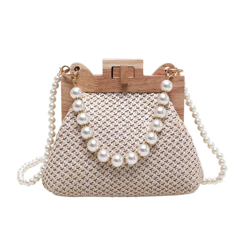 Women's soft straw woven horizontal square shoulder bag with pearl chain strap in beige colour.