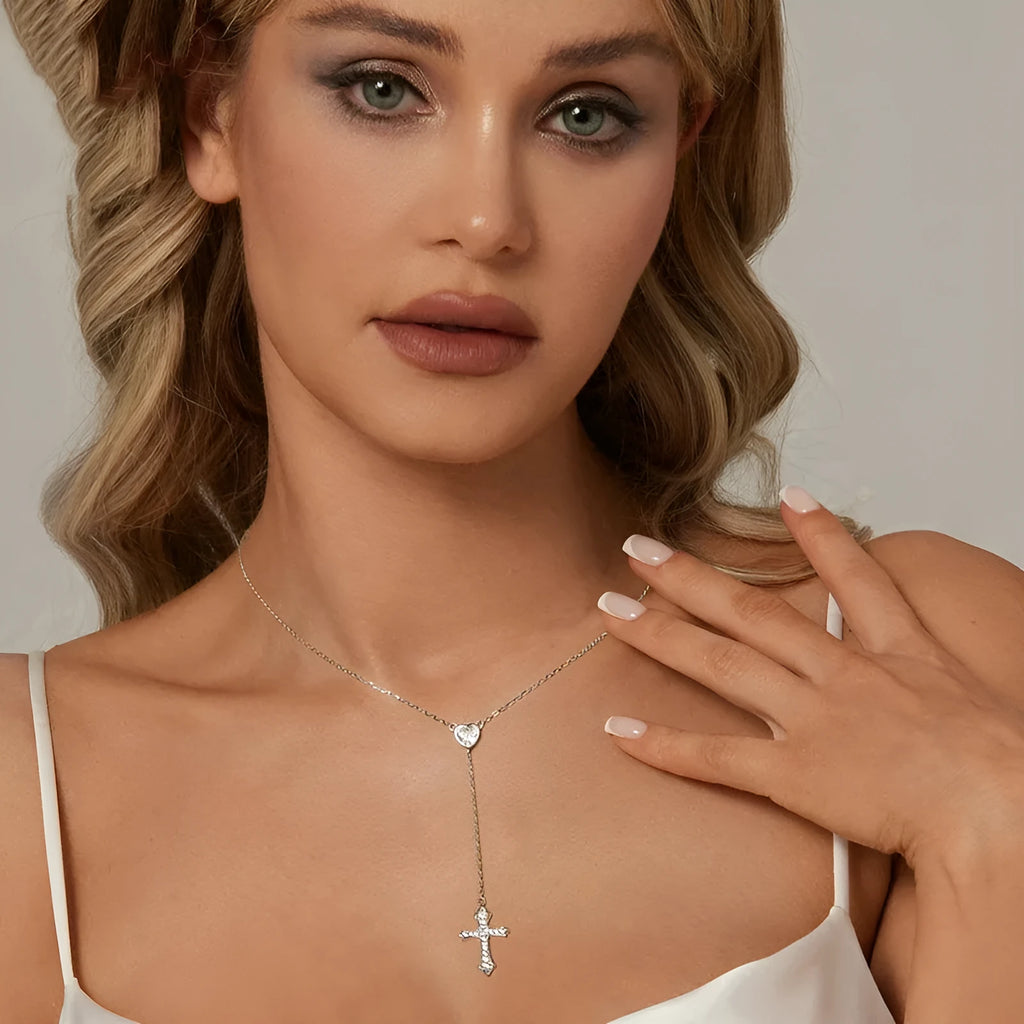 Close-up of a silver love cross necklace with an adjustable O-ring chain on an antique BSN384 finish.