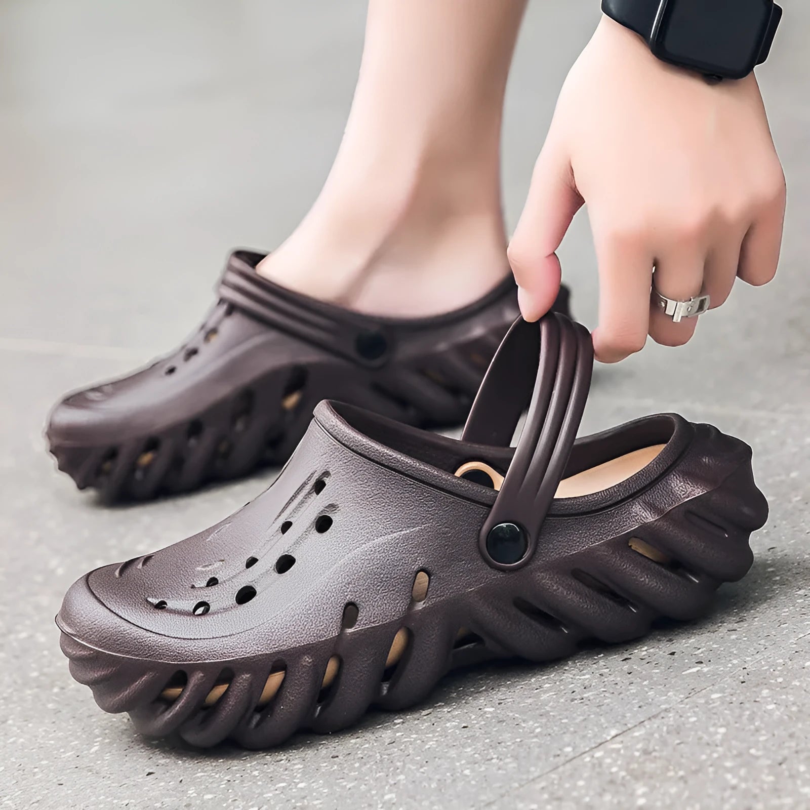 Men's beige EVA slipper sandals showing hollow-out design and non-slip sole pattern.
