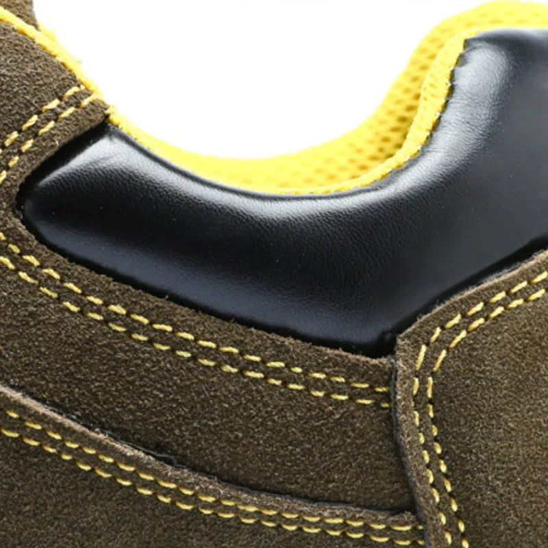 Bronze coloured low-cut cow suede safety work boots with a steel toe cap on a grey background