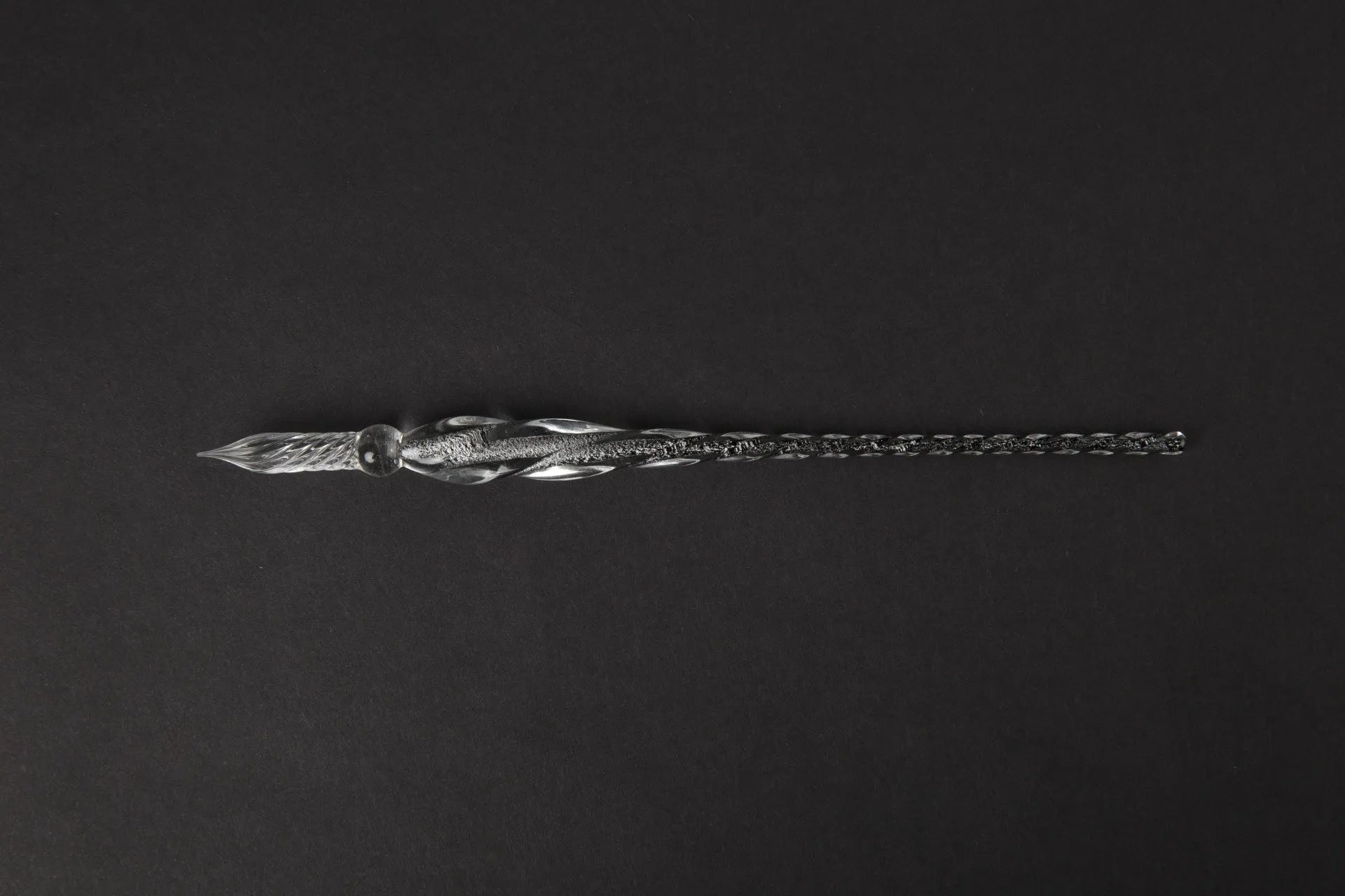 Transparent glass crystal pen with coloured ink visible inside, abstract modelling design