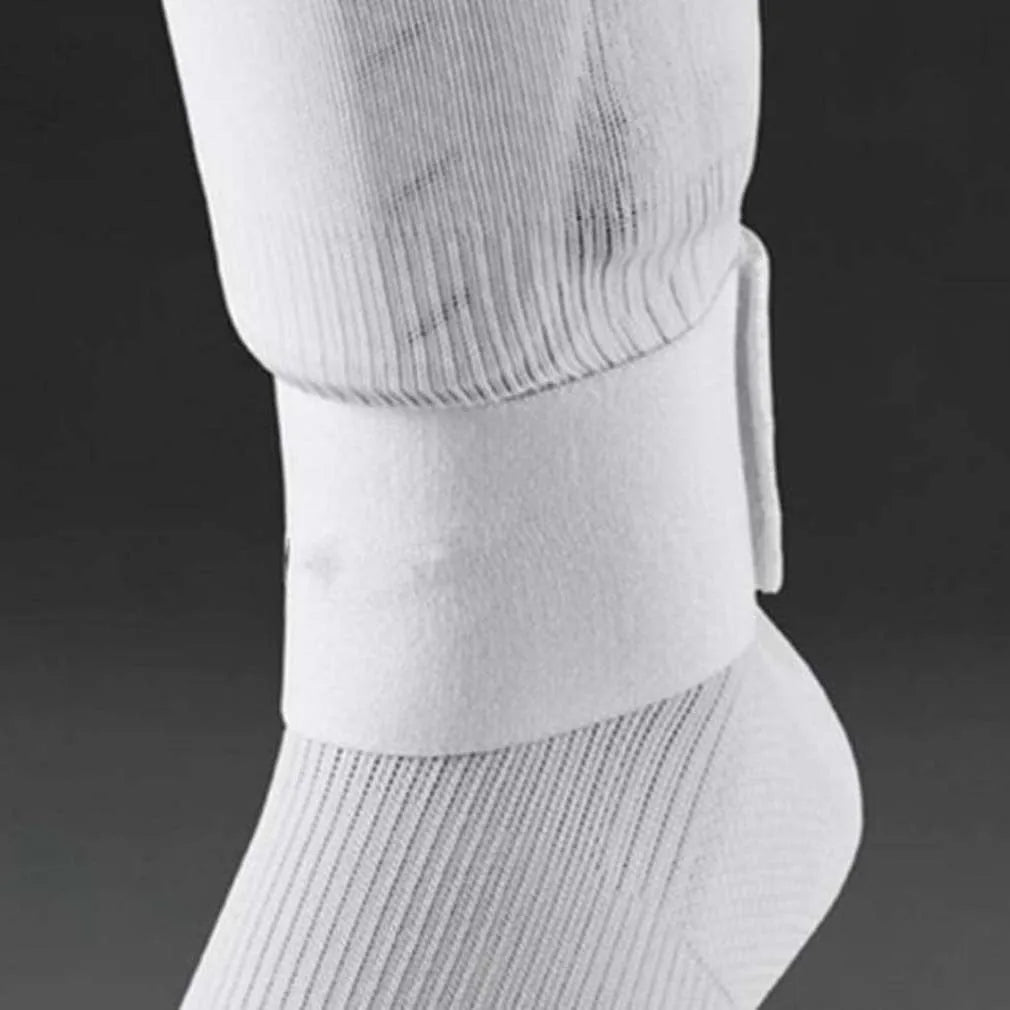 Red elastic rubber strap for securing football shin guards, shown next to shin pad