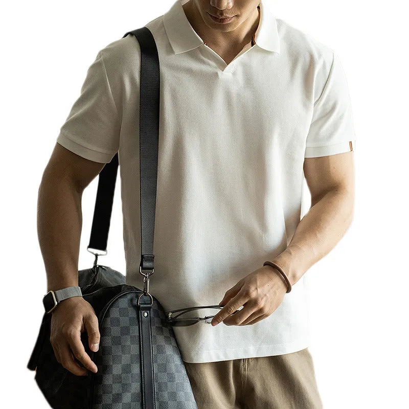 Man's short-sleeve blue polo shirt on a hanger, showing the classic collar and button placket.