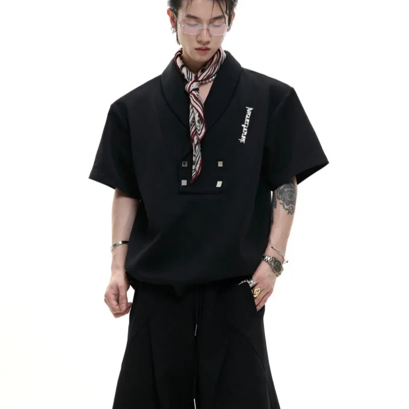 Men's dark grey cotton V-neck sports suit with padded shoulders, metal details, and matching shorts.