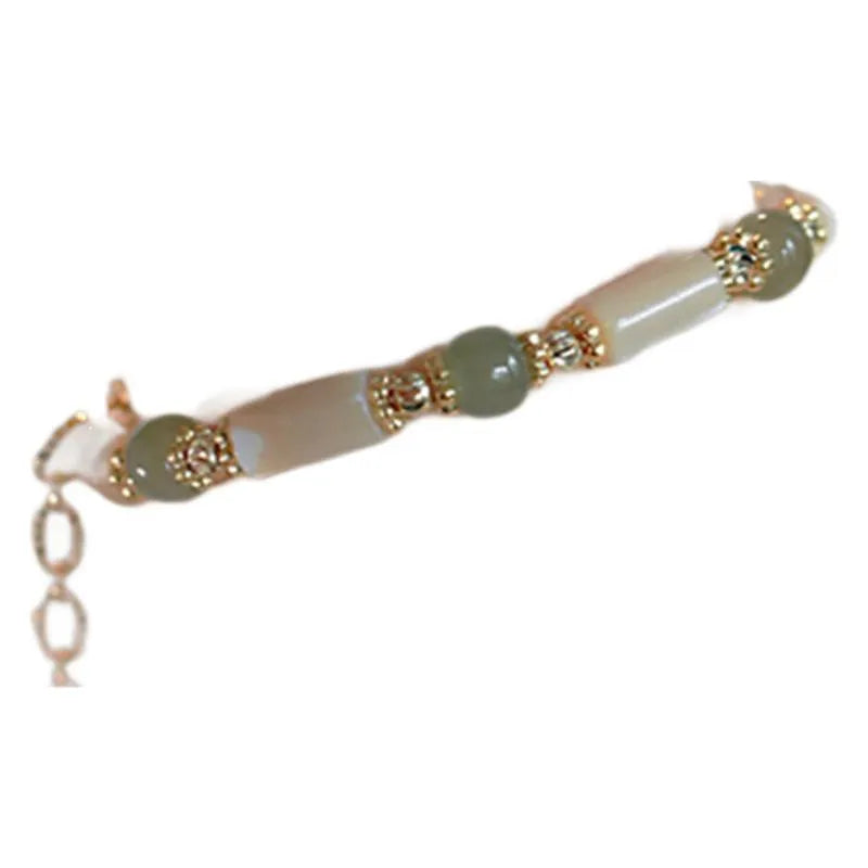 Natural Hetian jade white lip shell bracelet with geometric round beads on woman's wrist