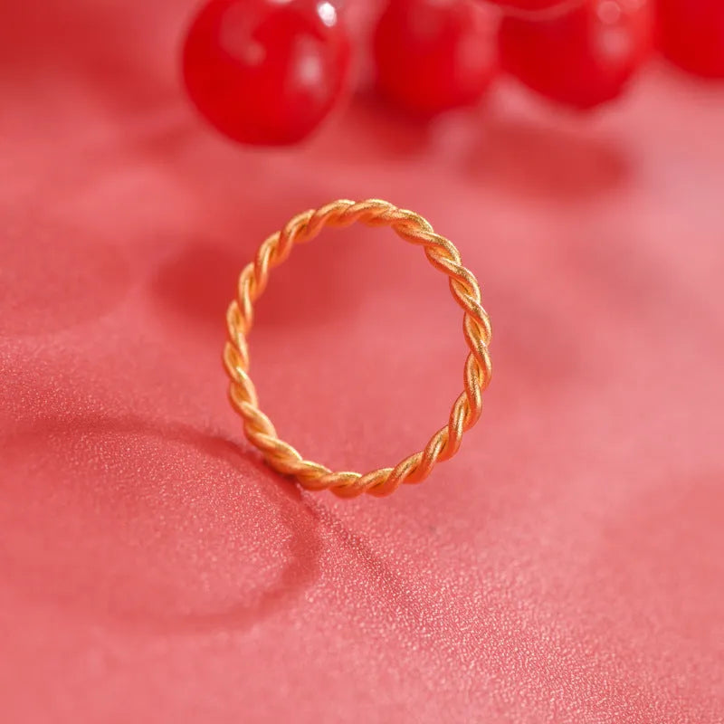 Brass gold plated women's ring showing simple bracelet and twist style options on a finger
