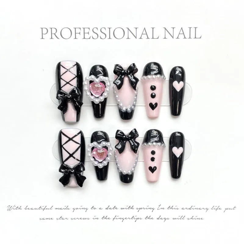 Black and pink peach heart hand-painted press on nails with bow detailing in cat eye gel style