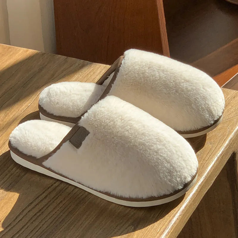 Solid-colour winter plush slippers with non-slip PVC sole on a home floor