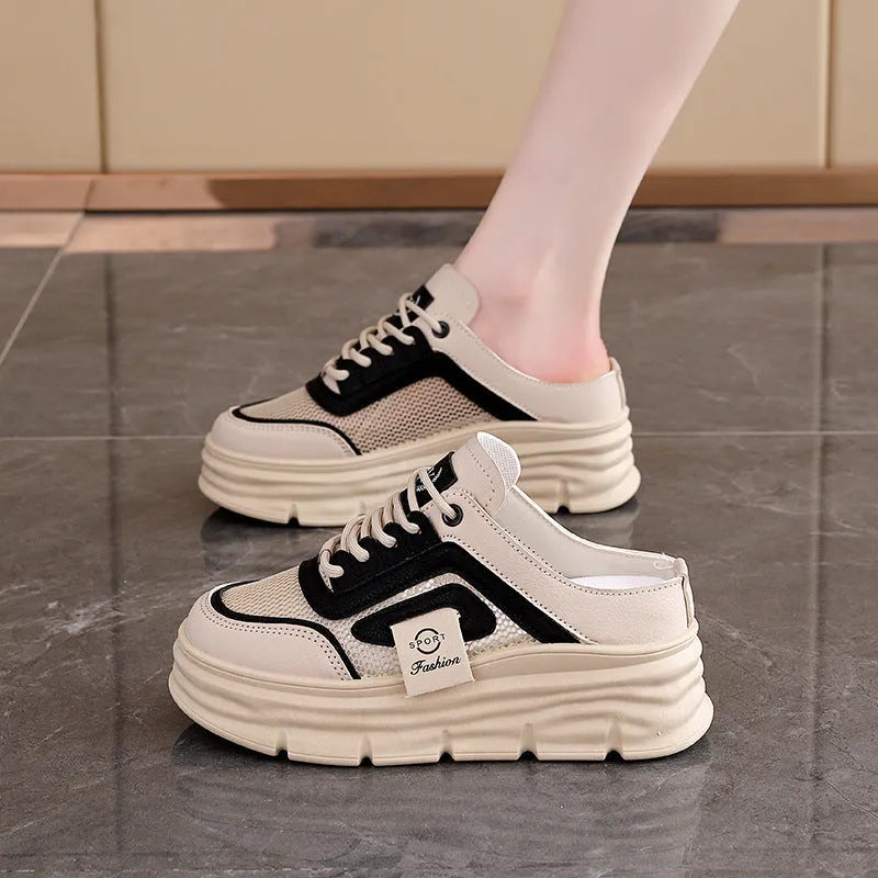 Women's black mesh half slipper with round toe, rubber sole, and height increase insole.