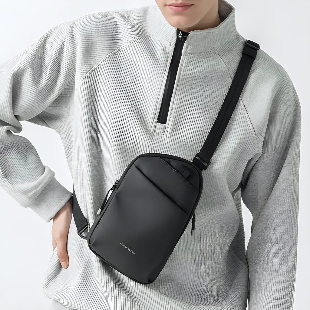 Men's black Oxford cloth crossbody bag showing reinforced stitching and simple design