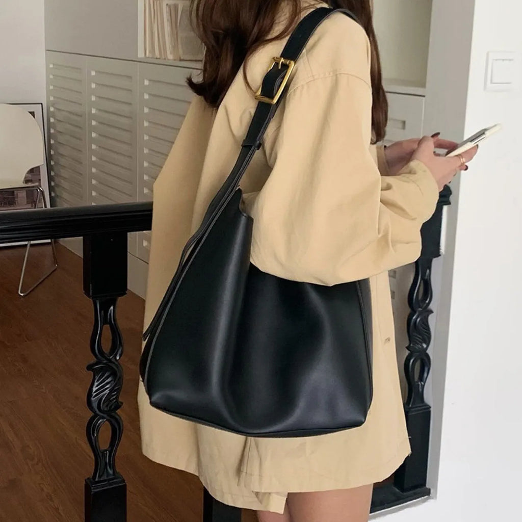 Women's soft PU leather shoulder bag with decorative swing threads in black or brown colour options