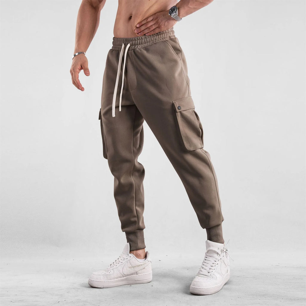 Men's loose ankle-tied cotton sports trousers in multi-pocket design showing apricot colour option