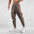 Men's loose ankle-tied cotton sports trousers in multi-pocket design showing apricot colour option