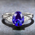 Women's court ring with natural blue zircon stones set in a delicate heart pattern on a silver-toned band.