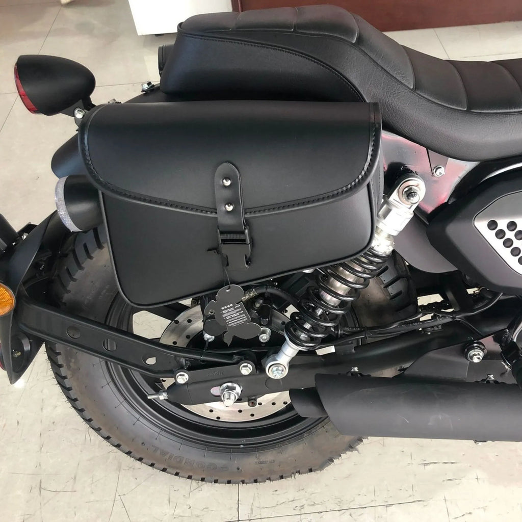 Black PU leather motorcycle swingarm saddlebag mounted on a Harley Sportster, showing side profile.