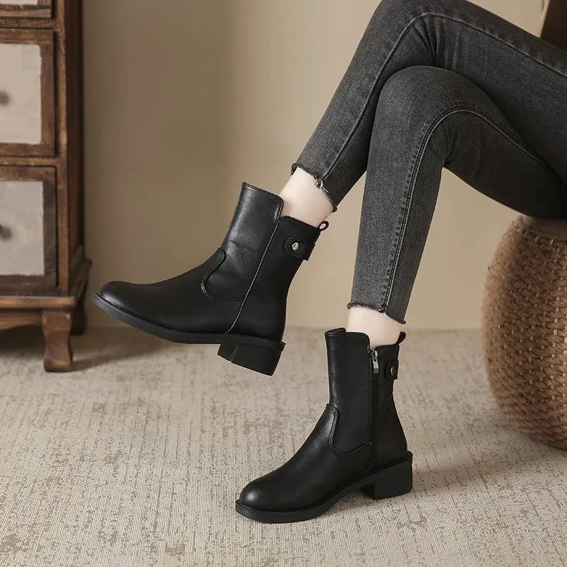 Black women's low heel ankle boots with side zip and round toe on a rubber sole