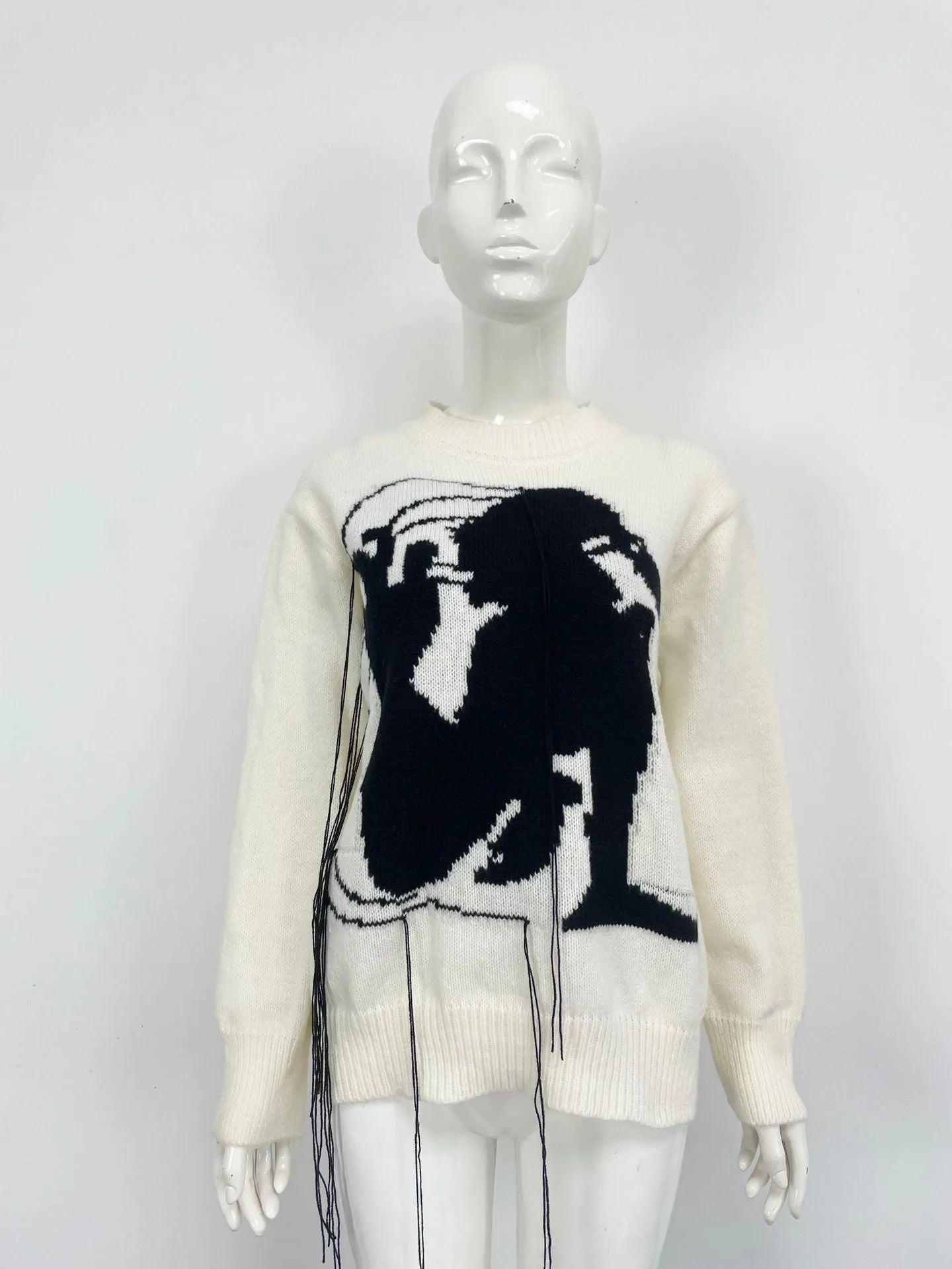 Women's loose grey alpaca wool sweater with tassel detailing and abstract pattern