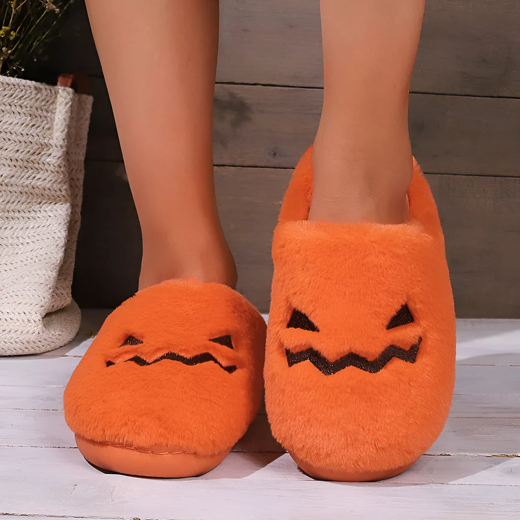 Orange Halloween pumpkin design plush slippers with a non-slip sole.