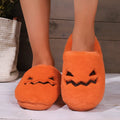 Orange Halloween pumpkin design plush slippers with a non-slip sole.
