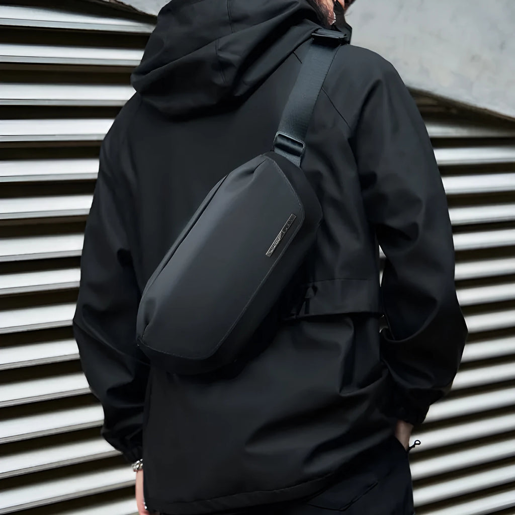Black men's messenger bag with cross-body strap and Oxford cloth construction