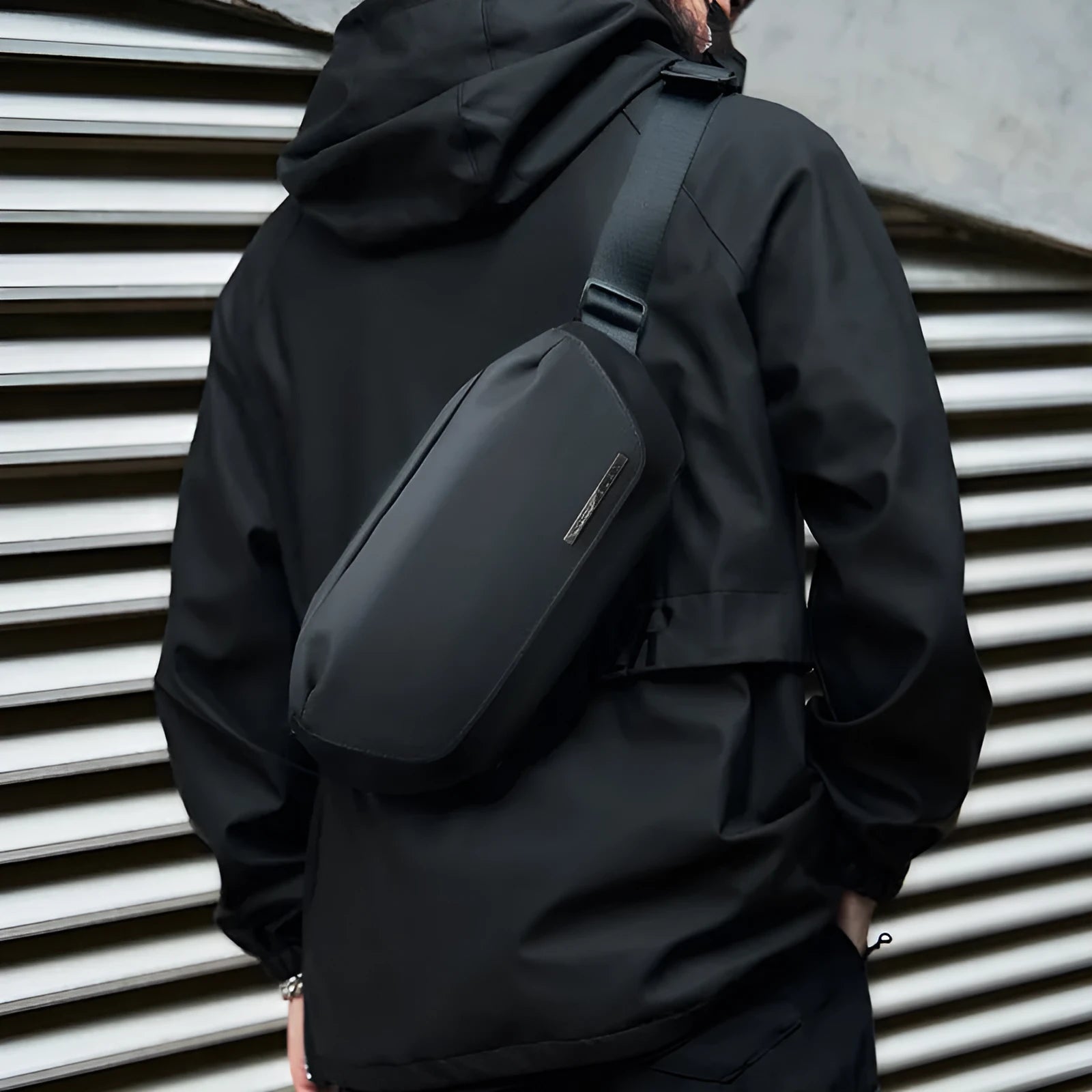 Black men's messenger bag with cross-body strap and Oxford cloth construction