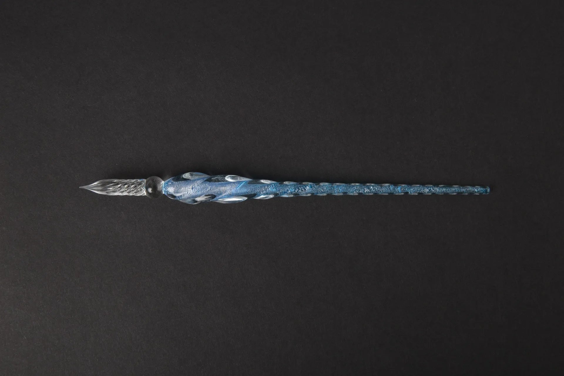 Transparent glass crystal pen with coloured ink visible inside, abstract modelling design