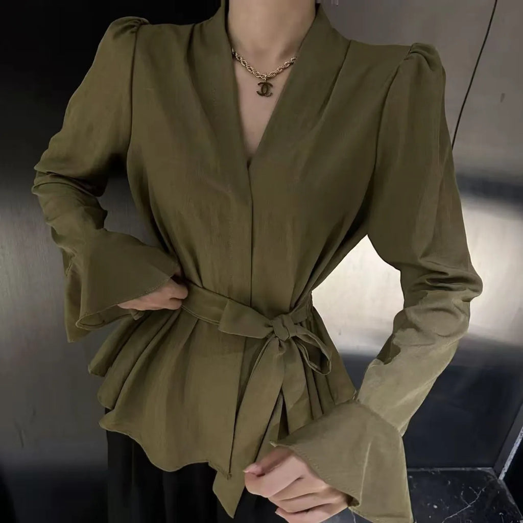 Women's black French-style shirt with irregular collar, tied front, and long bell sleeves.