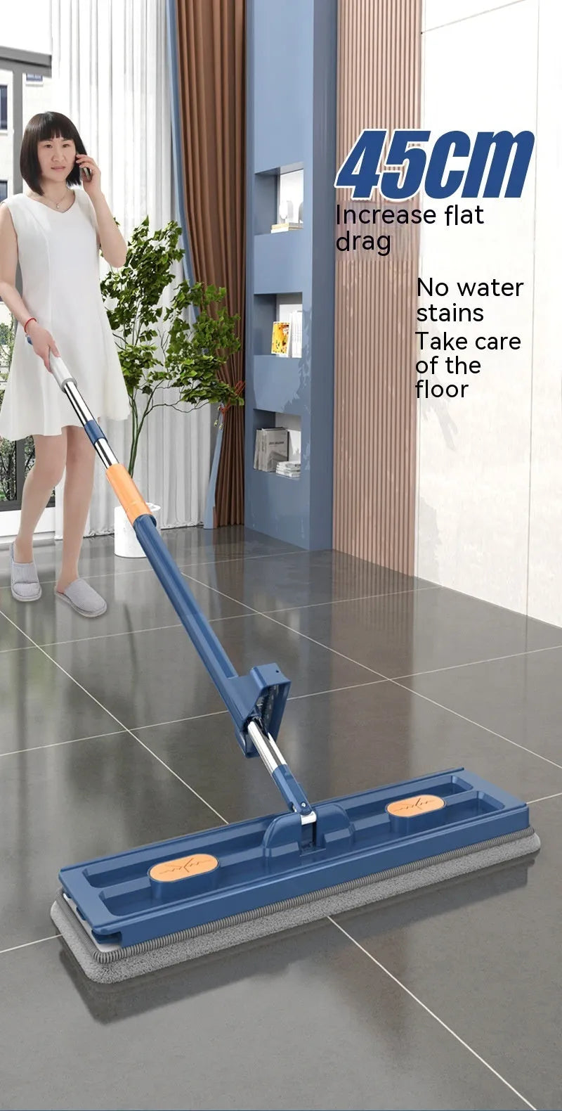 Large flat mop with blue rotating head and long stainless steel handle on a wooden floor