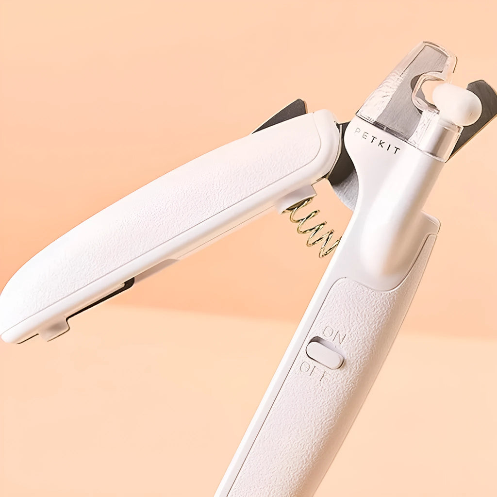 White LED pet nail clipper with a transparent anti-splash guard and a nail file on a white background.
