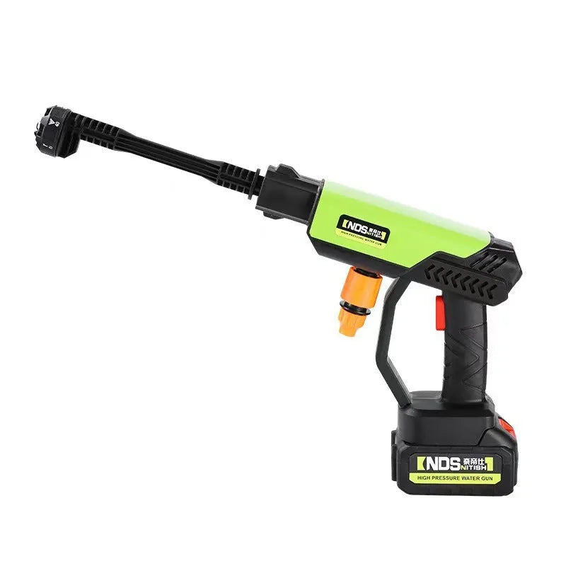 Green wireless high-pressure water gun with metal nozzle and set of cleaning accessories on a white background.