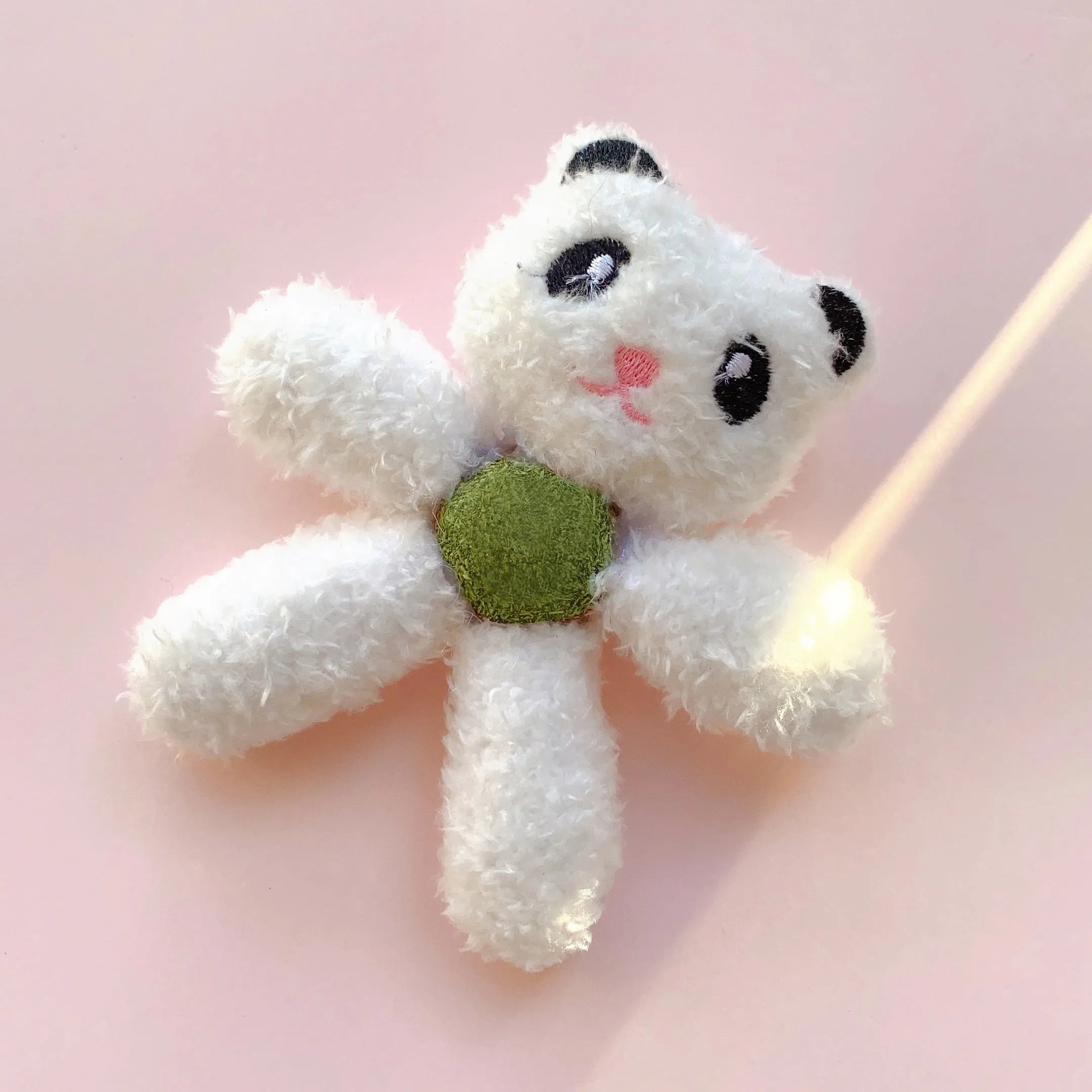 Brown bear shaped stuffed catnip ball edible chewing toy for cats on a white background.