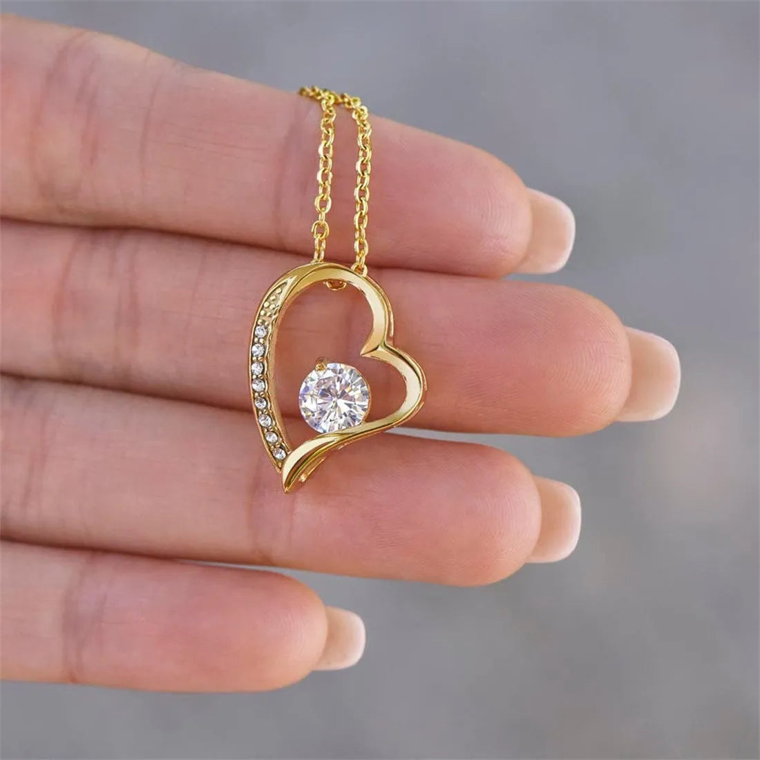Hollow heart-shaped necklace in gold or silver finish, presented with a card and gift box.