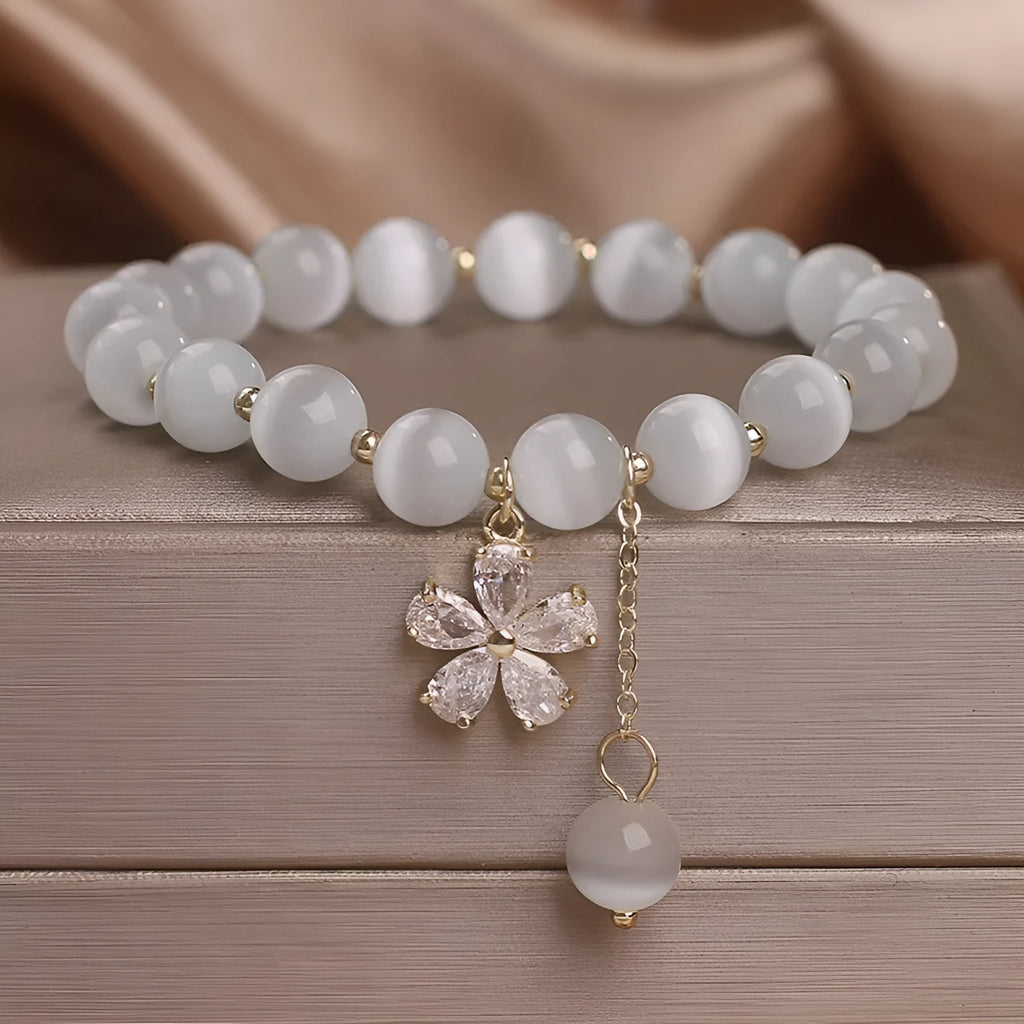 White cat's eye stone women's bracelet with flower tassel and morganite safety buckle pendant.
