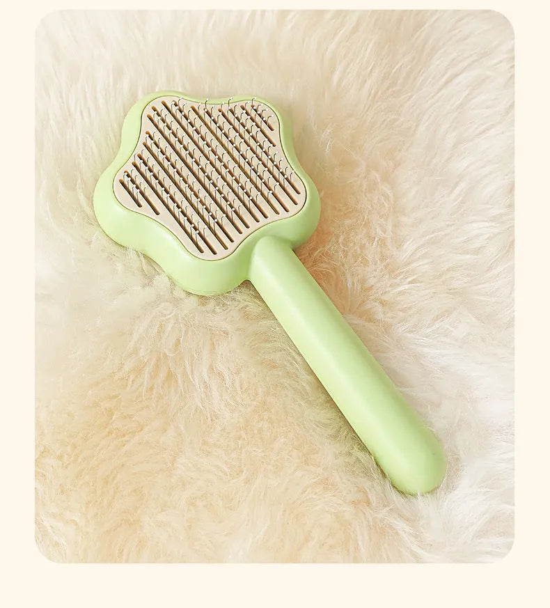 Green pet grooming comb with stainless steel needles and self-cleaning mechanism