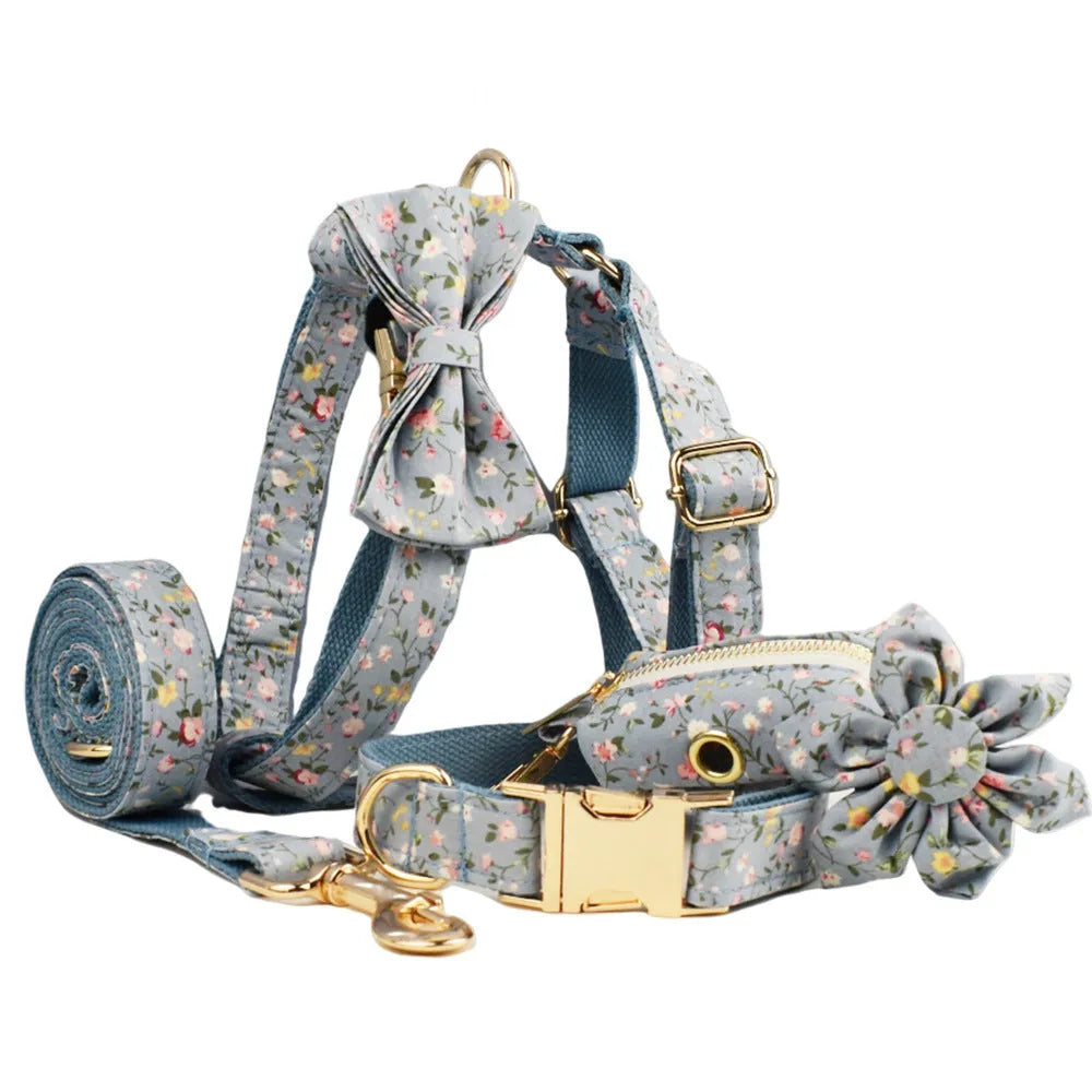 Blue floral patterned cloth dog collar with matching leash, vest, bow, and poop bag set for pet gifts